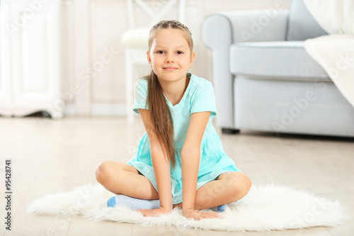 Little cute girl sitting on...