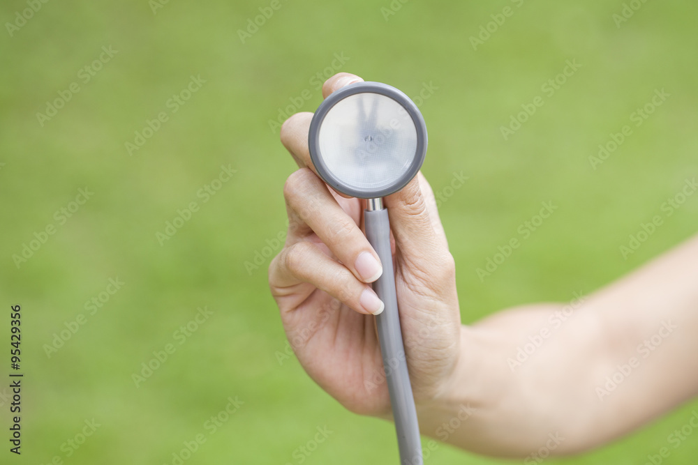 Fototapeta premium hand with stethoscope listening something