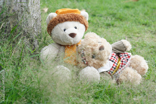 Teddy bears sitting on thewood floor with love. Concept about love and relationship © sittinan