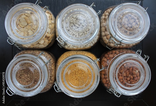 Grains and beans in glass jars in the kitchen