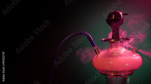 Purple hookah smoke on black background. slow motion photo