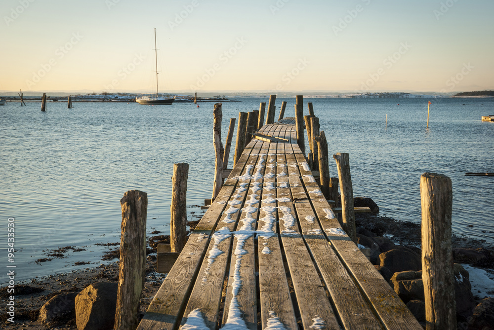 Fototapeta premium Wooden pier in snow at the sea, Norway