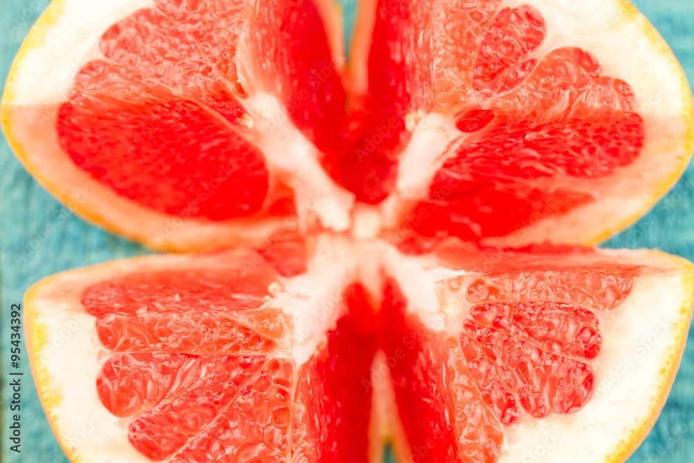 ripe fresh sliced grapefruit on a blue wooden background. Diet, vegetarianism, healthy food ripe fresh sliced grapefruit on a blue wooden background. Diet, vegetarianism, healthy food