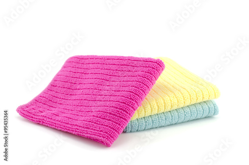 colorful stacked red,yellow and blue small bathroom towels on a white background