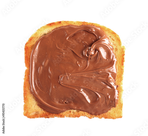 Chocolate poured on piece of bread isolated on white
