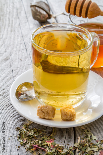 Herb tea in glass cup with honey