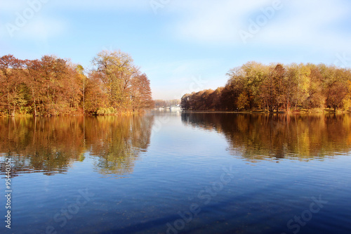 Beautiful autumn park. Autumn in Minsk. Autumn trees and leaves. Autumn Landscape.Park in Autumn. Mirror reflection of trees in water. Minsk city. Victory park in Minsk
