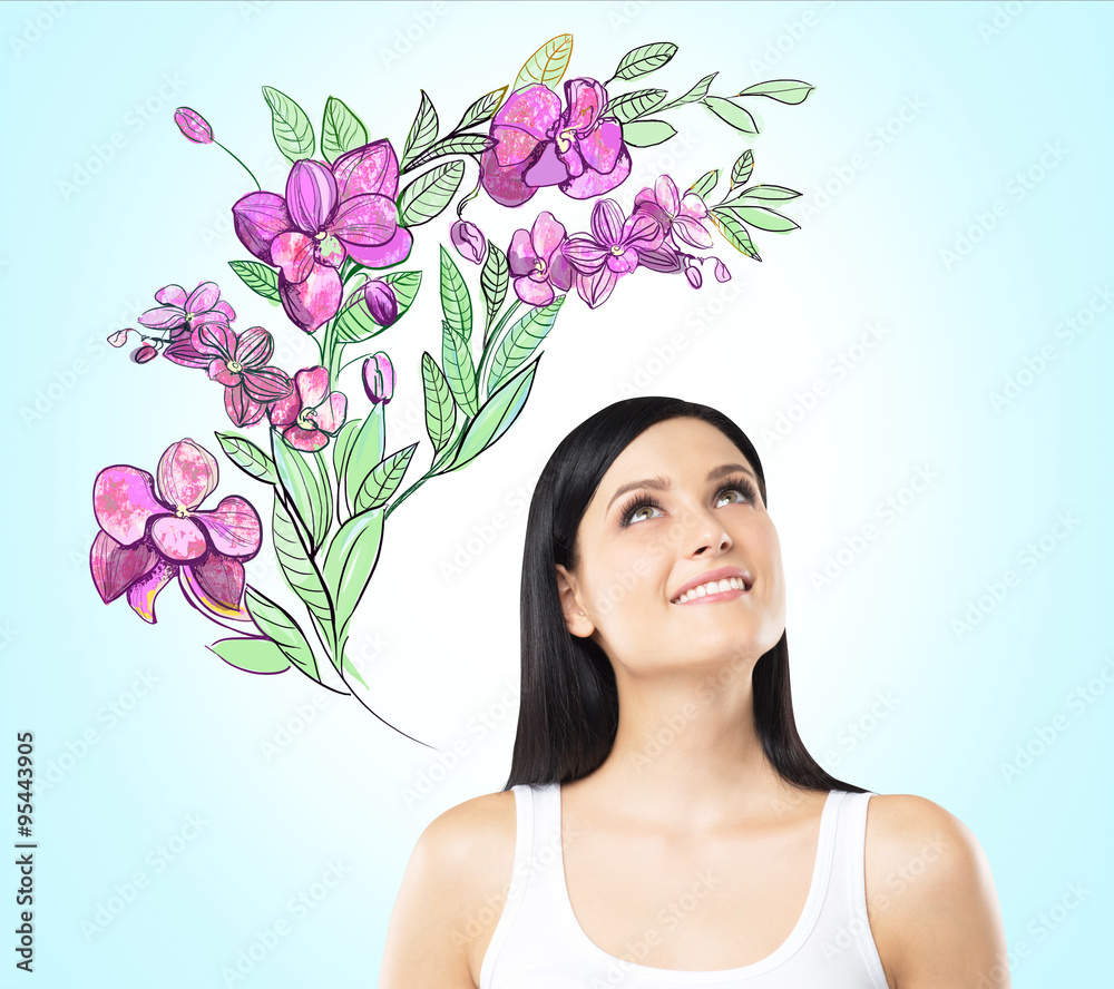 An inspired woman is dreaming about summer flowers. The sketch of purple flowers is drawn on the light blue background. An inspired woman is dreaming about summer flowers. The sketch of purple flowers is drawn on the light blue background.