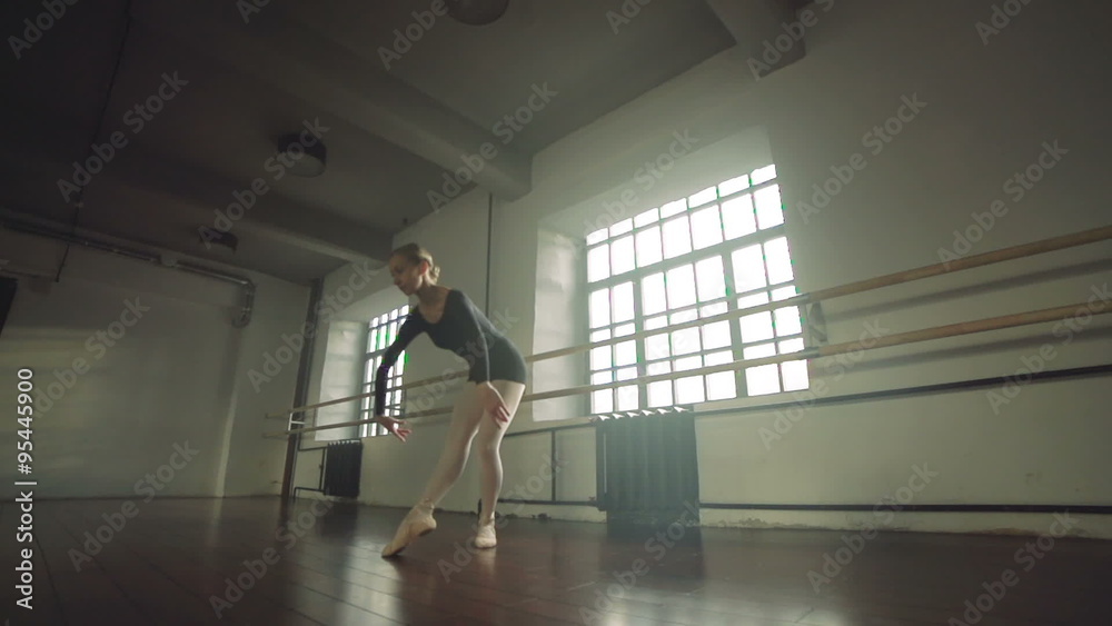 graceful girl practicing ballet in the Studio, slow motion , performs the elements of dance graceful girl practicing ballet in the Studio, slow motion , performs the elements of dance