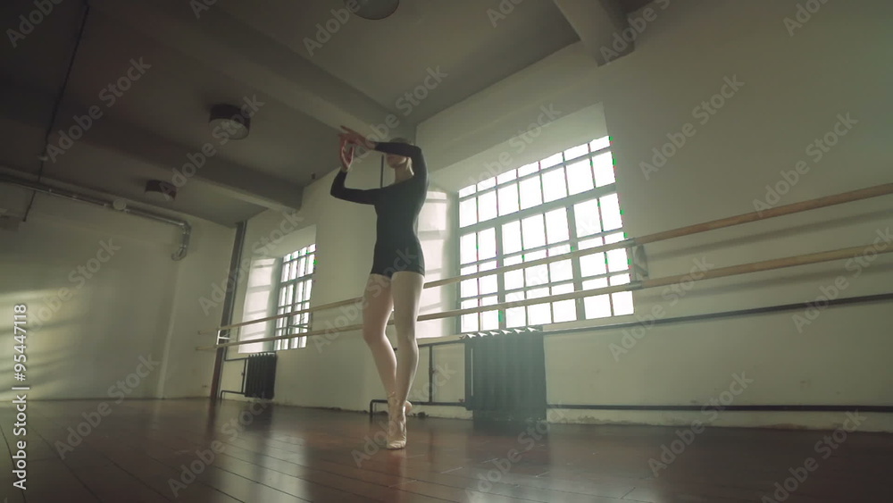 graceful girl practicing ballet in the Studio, slow motion , performs the elements of dance