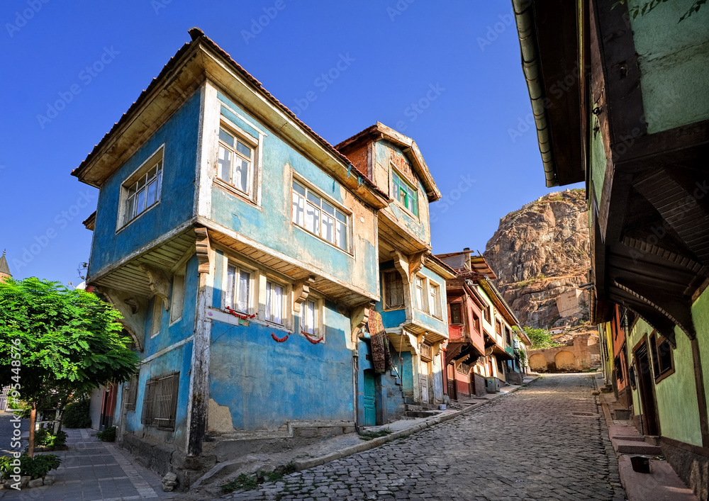 Old traditional ottoman house street with the Karahisar castle in Afyon, Turkey