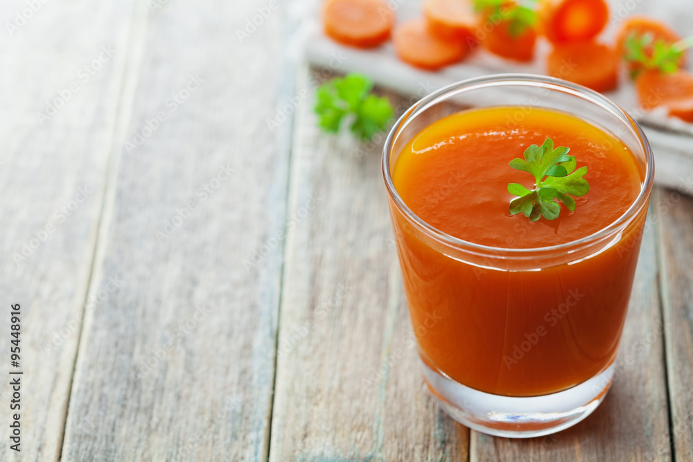 Fresh carrot juice in glass on wooden table, healthy vegetable drink Fresh carrot juice in glass on wooden table, healthy vegetable drink