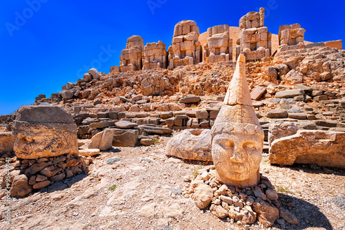 Antique statues on the top of Nemrut mountain at sunrise, Turkey photo