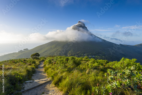 Tourist hikers up Cape Town, Table Mountain landscape, overlooking Lions Head peak photo