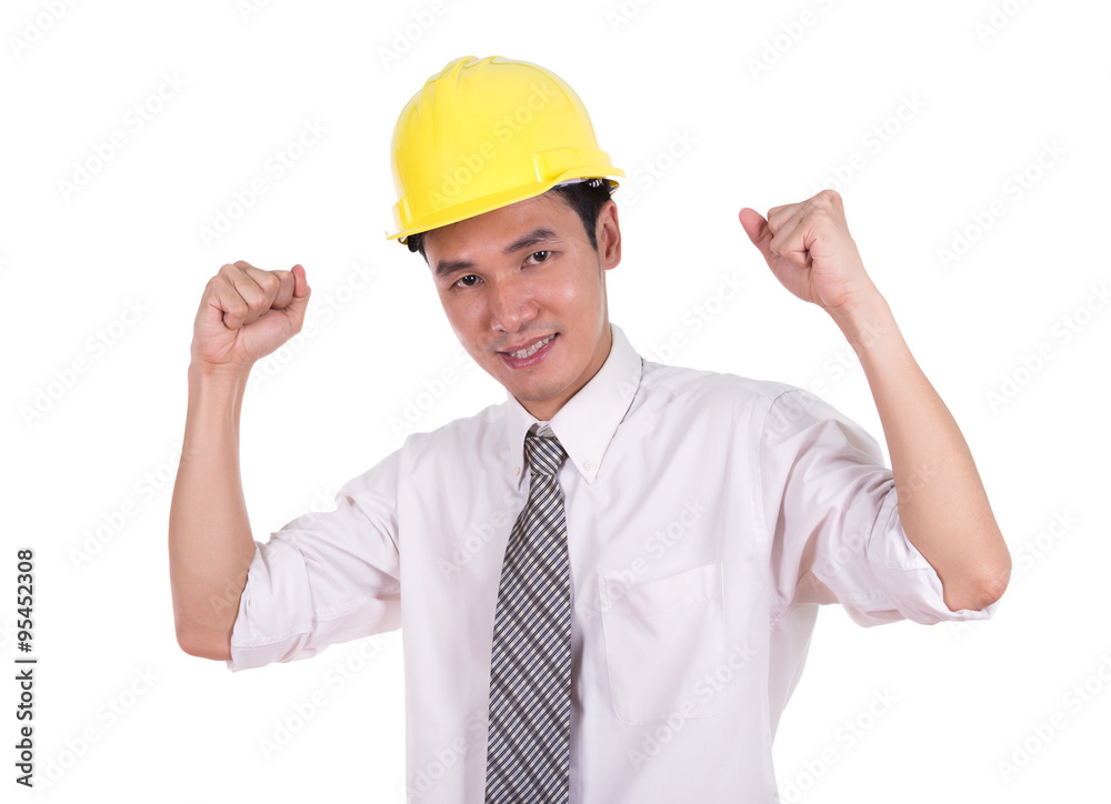 Happy young engineer celebrating with arm raised, concept of suc Happy young engineer celebrating with arm raised, concept of suc