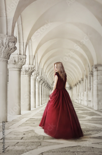 Woman in red dress near ancient columns, San Marco Square, Venice, Italy