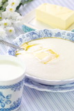 Semolina porridge with fresh butter and mug of milk
