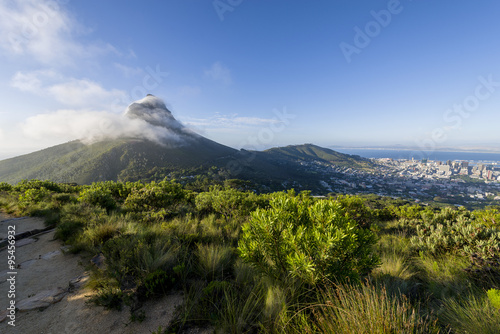 Tourist hikers up Cape Town  Table Mountain landscape  overlooking Lions Head peak