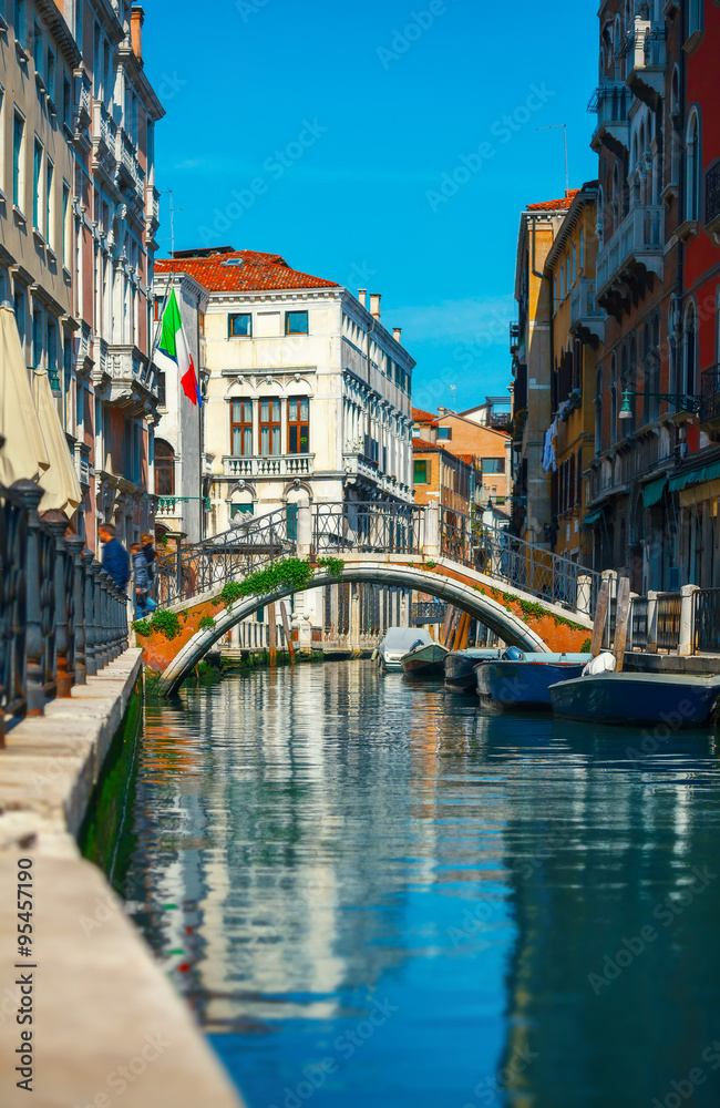 Bridge over channel among houses in Venice Italy