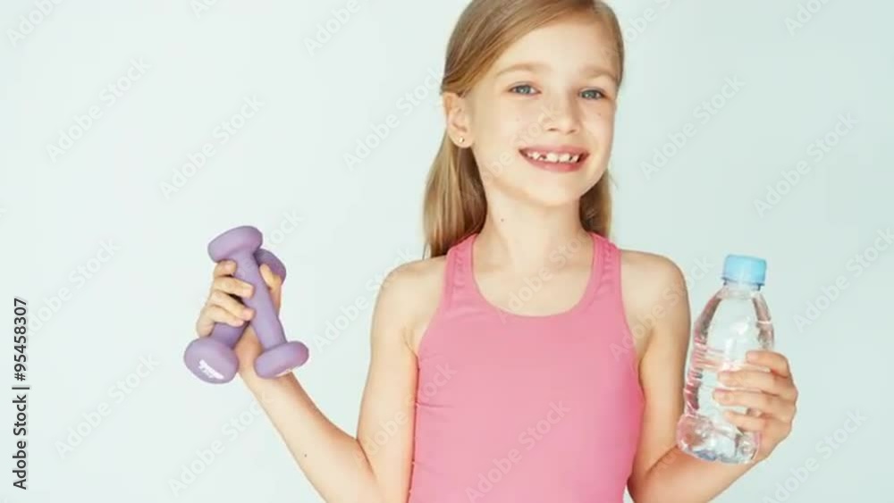 Closeup portrait girl holding dumbbell on a white background Closeup portrait girl holding dumbbell on a white background