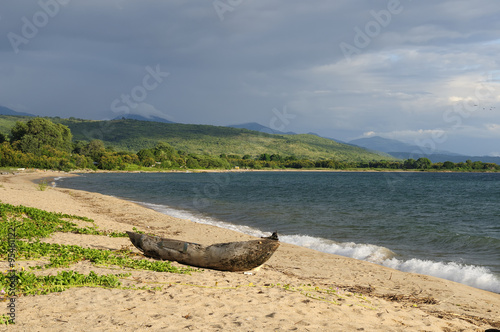 Traditional dugout canoe on the beach on the lake Malawi photo
