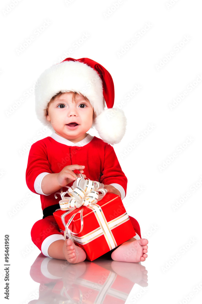 Funny little boy in Santa Claus suit with gift boxes. Happy New Year and christmas holidays Funny little boy in Santa Claus suit with gift boxes. Happy New Year and christmas holidays