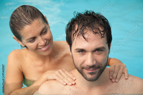 Pretty woman giving a massage to her boyfriend