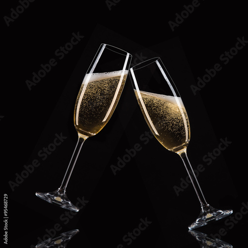Glasses of champagne with splash, celebration theme.