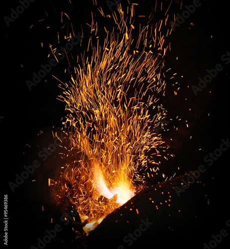 The flame sparks from a forge