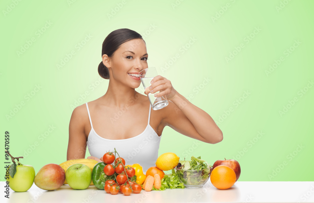 woman with fruits and vegetables drinking water woman with fruits and vegetables drinking water