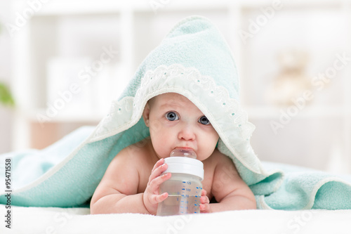 adorable child baby drinking water from bottle