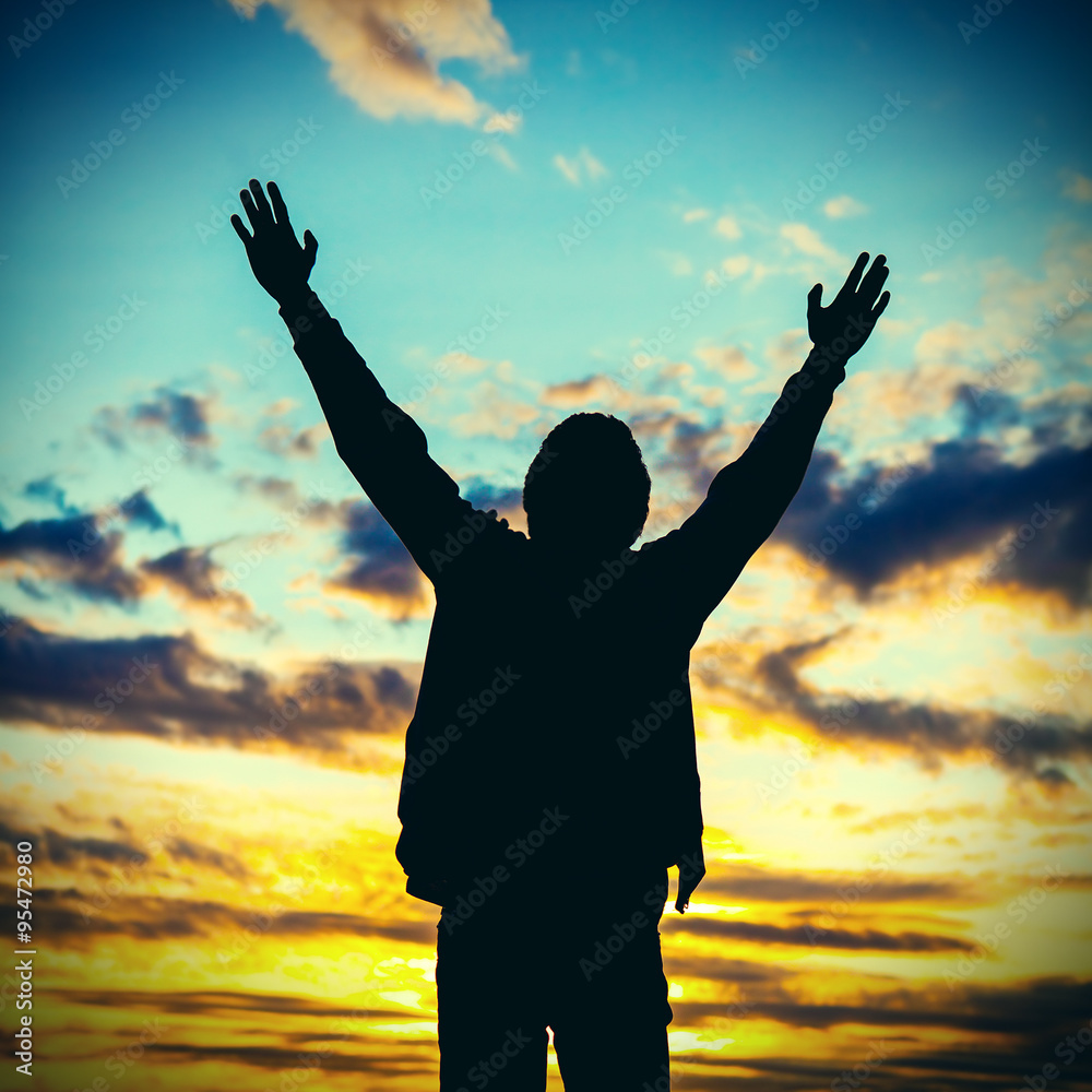Fototapeta premium Man praying on Sunset Background
