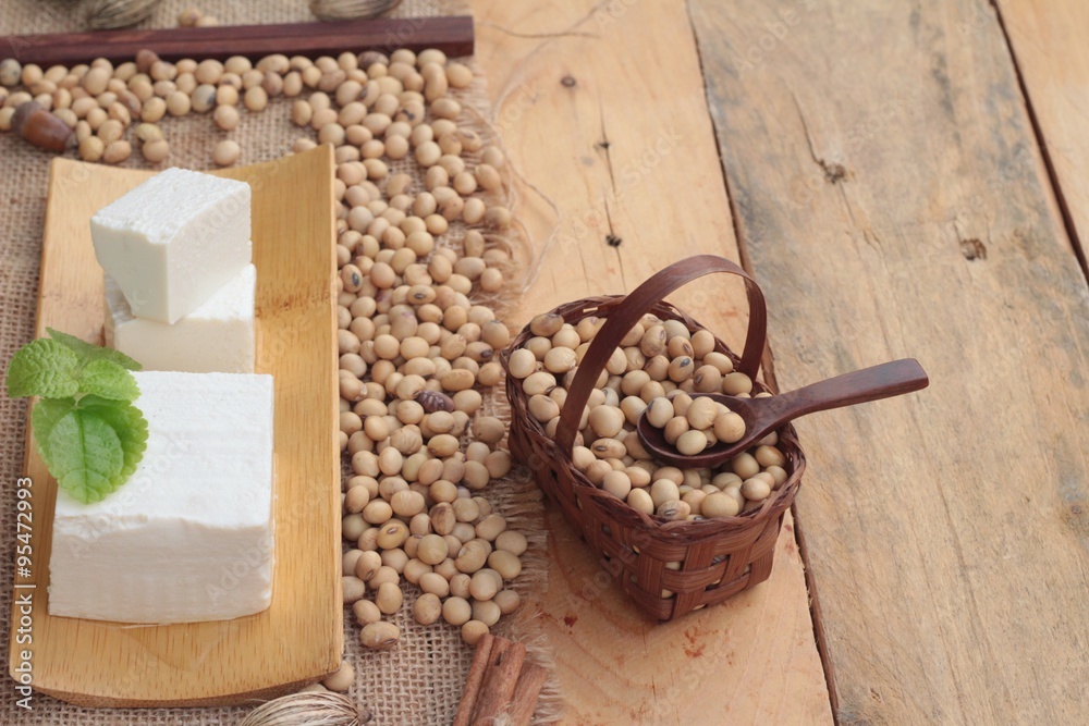 Fototapeta premium Tofu and soybeans on wood background.