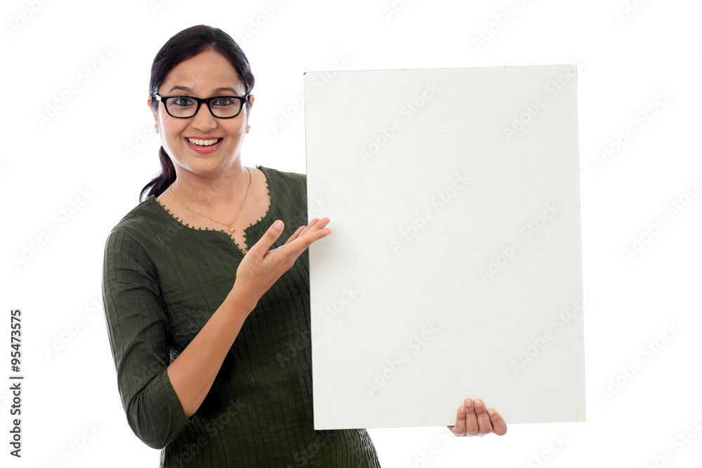 Cheerful young woman holding empty white board Cheerful young woman holding empty white board