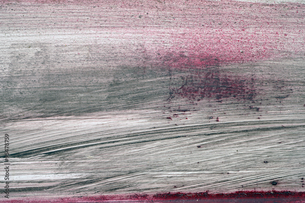 Brushstroke with black and red paint on dusty metal fence Brushstroke with black and red paint on dusty metal fence