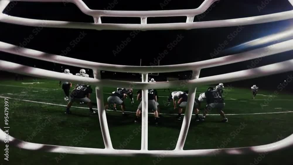 First person point of view from inside a football player's helmet, as the player makes a touchdown
