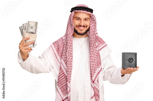 Tableau sur toile Arab holding money and a small metal safe