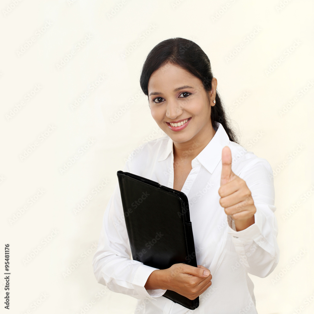 young happy business woman with black folder and making thumbs u young happy business woman with black folder and making thumbs u