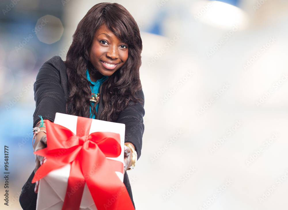 happy black woman holding a gift happy black woman holding a gift