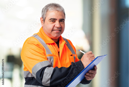 portrait of a worker writing on a paper