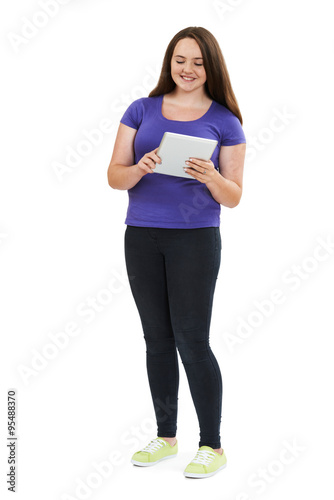 Full Length Studio Shot Of Teenage Girl Using Digital Tablet © highwaystarz