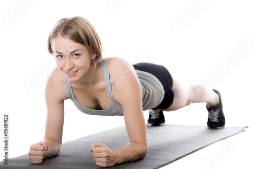 Sporty woman doing plank exercise