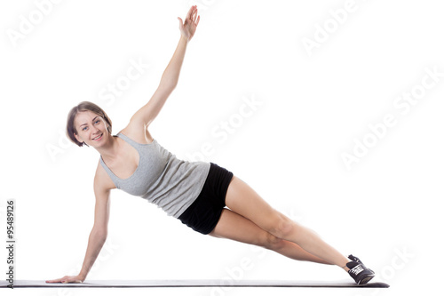 Sporty woman doing side plank exercise