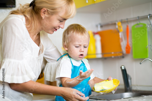 Mother And Son Cleaning Dis...