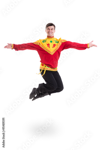 young man wearing a folk russian costume jumping against isolated white with copyspace