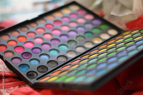 Makeup palette blurry background. Professional cosmetics, makeup palette of different colors and shades