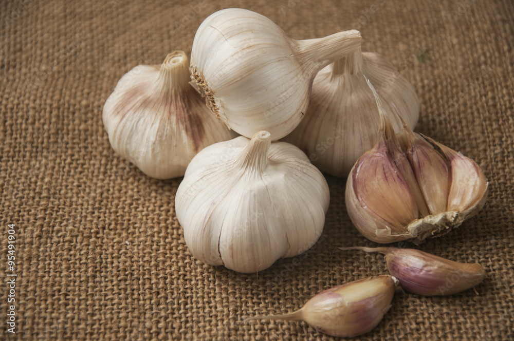Garlic close-up on sacking. burlap background Garlic close-up on sacking. burlap background