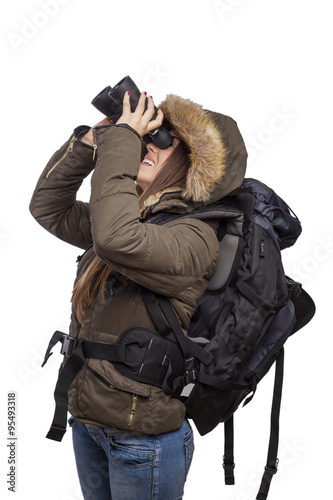 beautiful young woman hiker looking through binoculars
