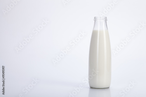 Old bottle glass of milk on white background.