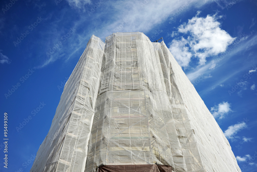 Reform of a building, scaffolding and tarps on the facade Reform of a building, scaffolding and tarps on the facade